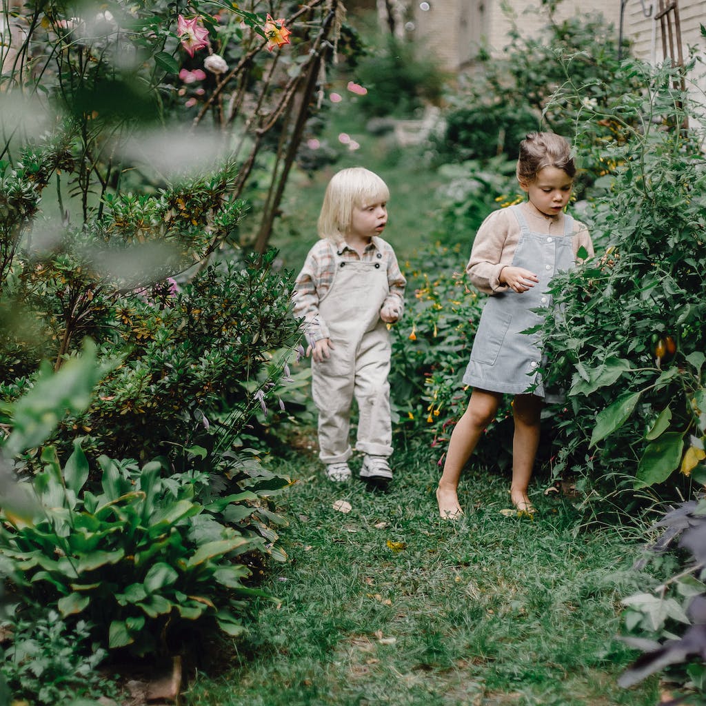 Siblings exploring the garden