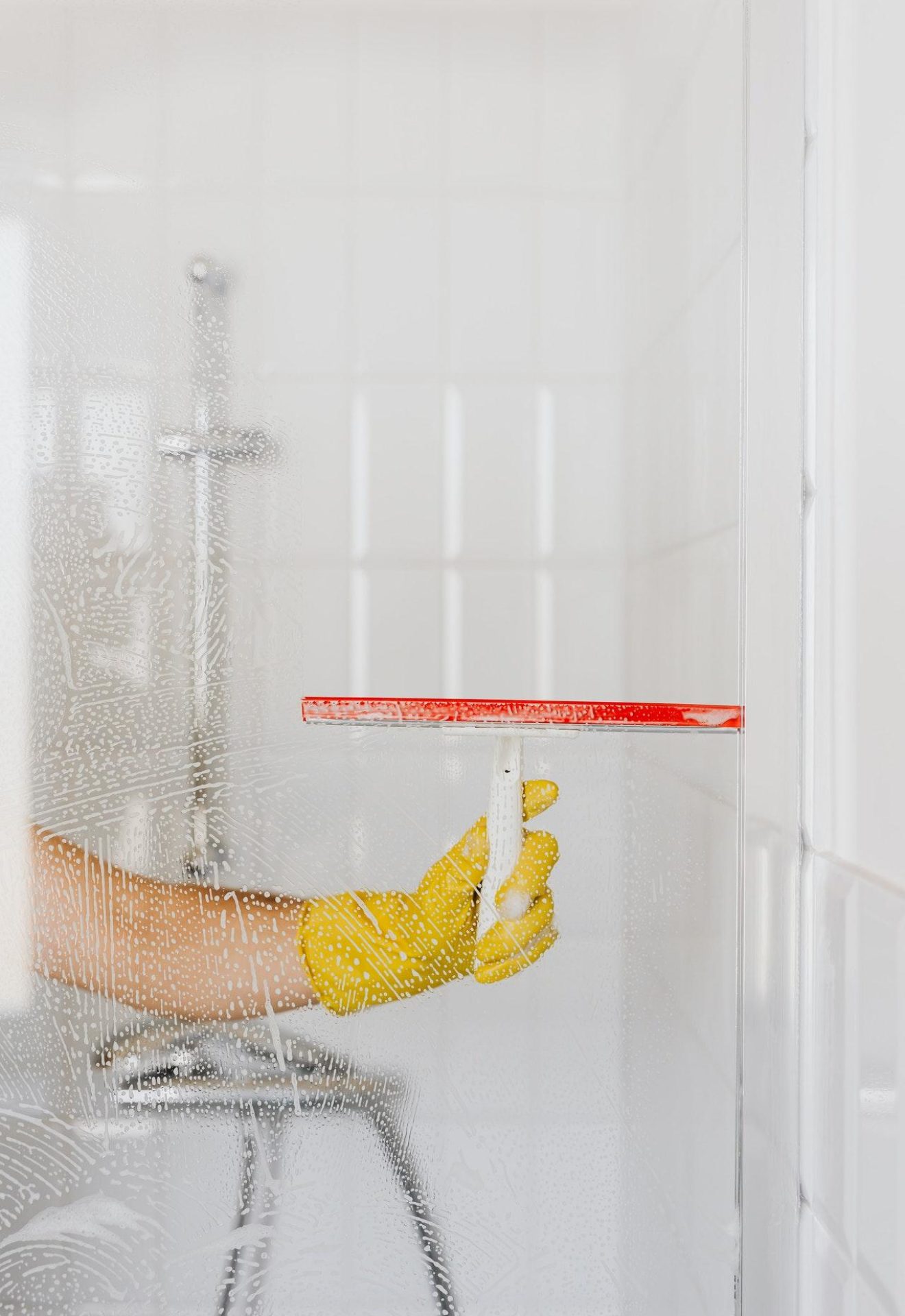 Shower glass being cleaned with a squeegee