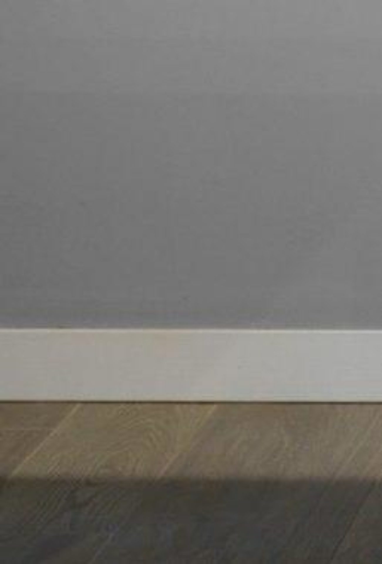 Grey wall with white skirting board