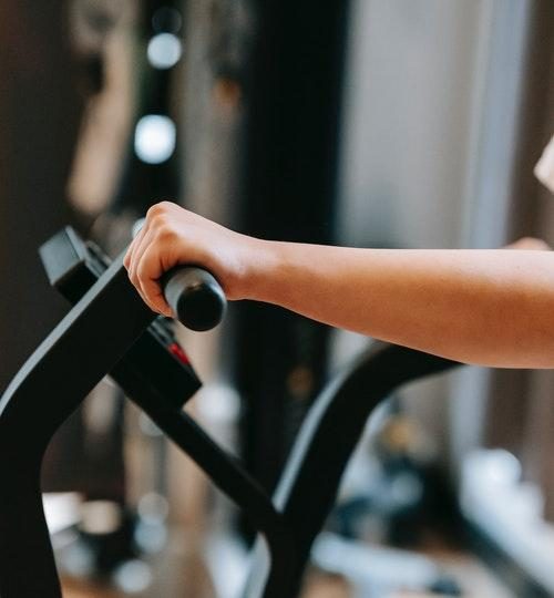 Person exercising on cross trainer exercise machine