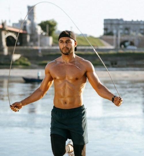 Man skipping in front of a river