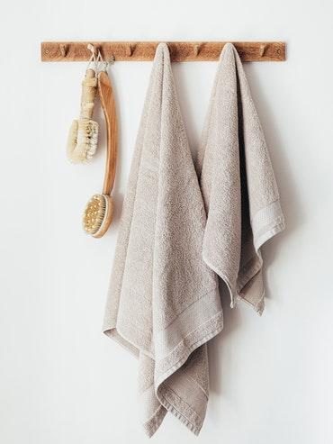 Wooden hanger with towels and body brushes